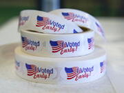 FILE - Rolls of "I Voted Early" stickers await voters in the final hours of early voting in the primary election in Noblesville, Ind., May 2, 2022. Election Day is still 12 days away. But in courtrooms across the country, efforts to sow doubt over the outcome have already begun.