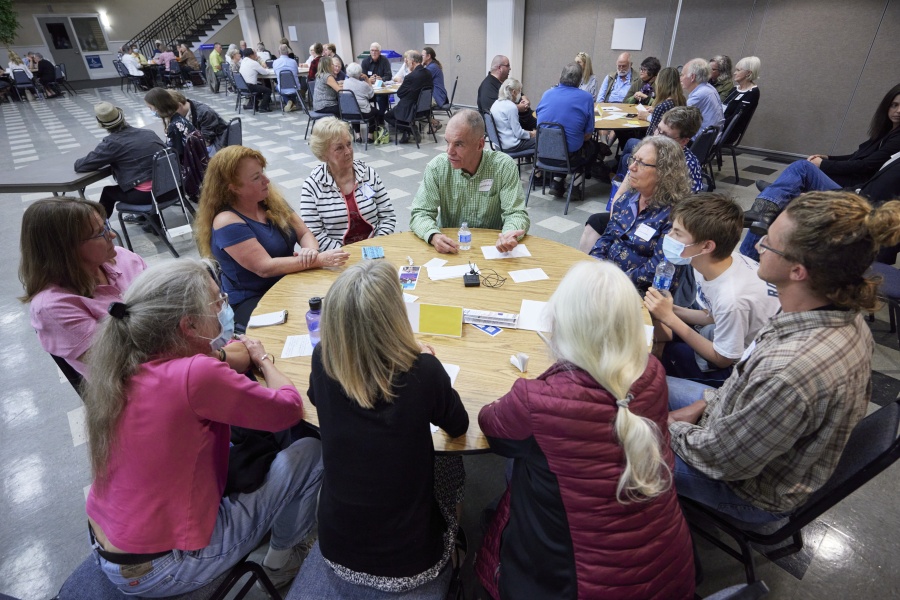 Democrat Paddy McGuire, incumbent Mason County auditor, in green shirt, talks with voters during a "candidate speed-dating"-style forum Oct. 13 in Shelton.