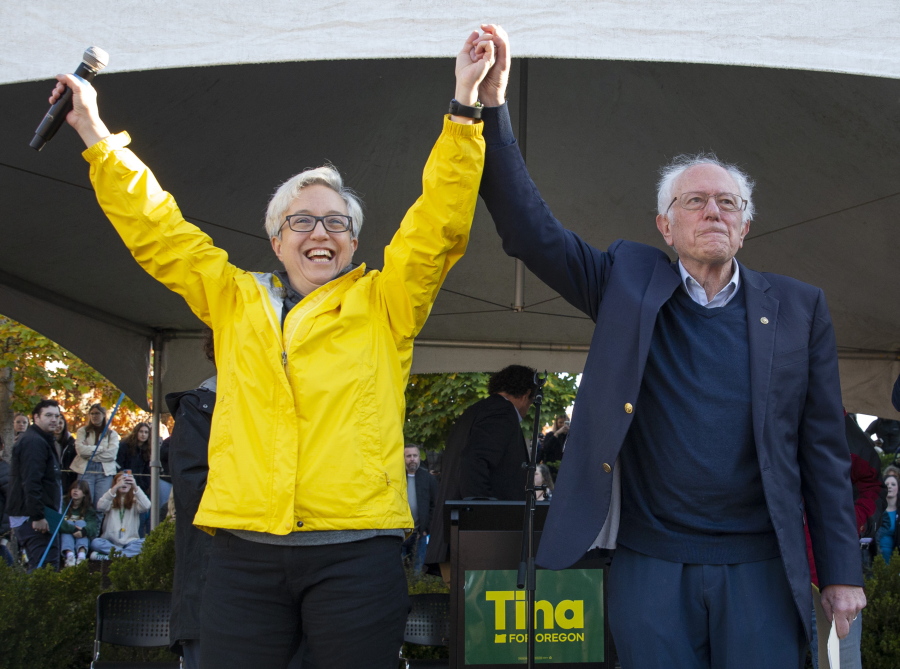 Oregon Democratic gubernatorial candidate Tina Kotek, left, and Vermont Sen. Bernie Sanders acknowledge the crowd during a visit to the University of Oregon campus in Eugene, Ore., Thursday, Oct. 27, 2022.  Sanders kicked off an eight-state tour Thursday, hoping to energize young voters and shore up support for vulnerable Democratic candidates ahead of the midterm elections.