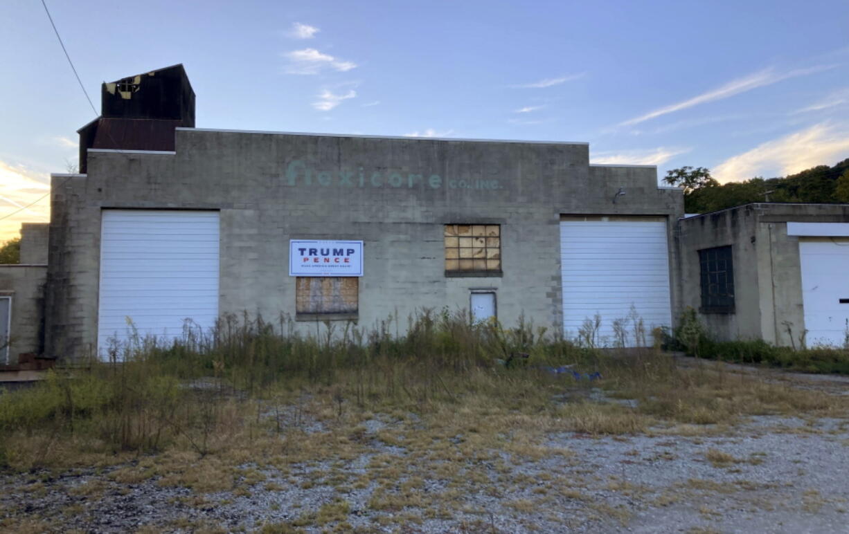 Trump-Pence sign hangs on a building off of Main Street in Monongahela, Pa., on Sept. 23, 2022. The sign is a lasting vestige of the campaign fervor that roused voters to the polls, including many who still believe the falsehood that the former president didn't lose the 2020 election and hope he will run again in 2024.
