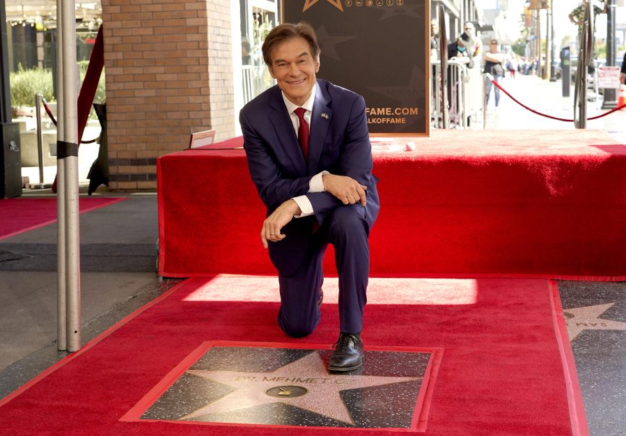 FILE - Mehmet Oz, the former host of "The Dr. Oz Show," poses atop his new star on the Hollywood Walk of Fame during a ceremony on Feb. 11, 2022, in Los Angeles. Oz may have made his reputation as a surgeon. But he made a fortune as a salesman on daytime TV. Now he is trying to leverage his celebrity as the Republican candidate in a bitterly contested U.S. Senate race in Pennsylvania.