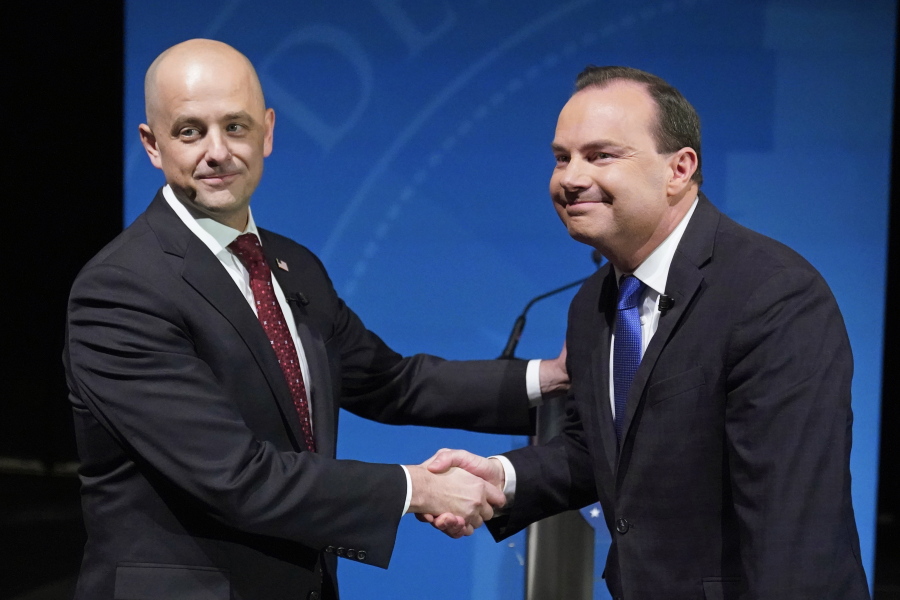 Utah Republican Sen. Mike Lee, right, and his independent challenger Evan McMullin shake hands before their televised debate, Monday, Oct. 17, 2022, in Orem, Utah, three weeks before Election Day. The debate will be the only time the candidates appear together in the lead-up to next month's midterm elections.