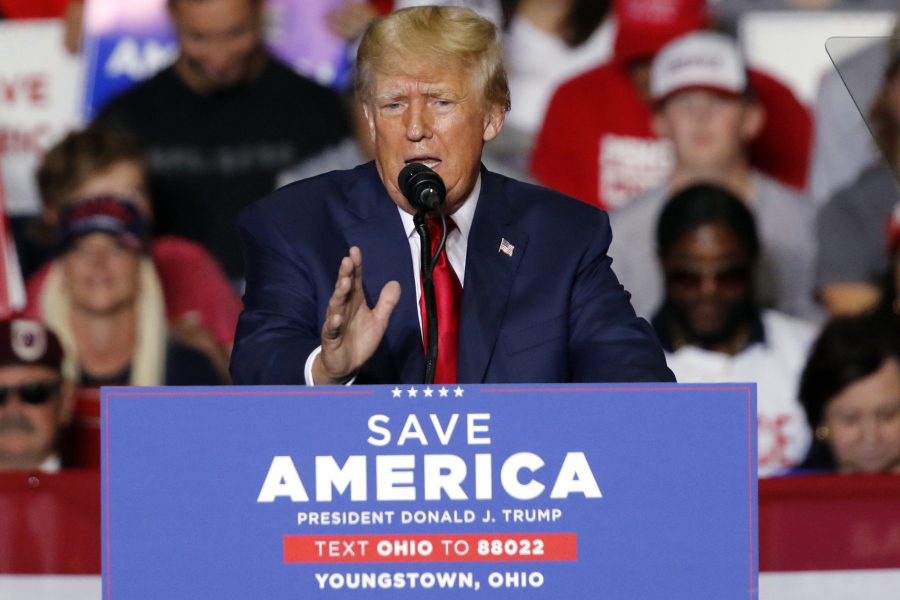 FILE - Former President Donald Trump speaks at a campaign rally in Youngstown, Ohio., Sept. 17, 2022. Trump is finally opening his checkbook and reserving millions of dollars in airtime for ads to bolster his endorsed candidates in key midterm races just one month before Election Day. Trump's newly-formed MAGA Inc. Super PAC has so far placed reservations in Pennsylvania, Ohio and Arizona, according to the ad tracking firm AdImpact. (AP Photo/Tom E.