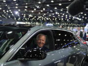 FILE - President Joe Biden drives a Cadillac Lyriq through the showroom during a tour at the Detroit Auto Show, Sept. 14, 2022, in Detroit. Biden, a self-described "car guy,'' often promises to lead by example by moving swiftly to convert the sprawling federal fleet to zero-emission electric vehicles. But efforts to help meet his ambitious climate goals by eliminating gas-powered vehicles from the federal fleet have lagged.