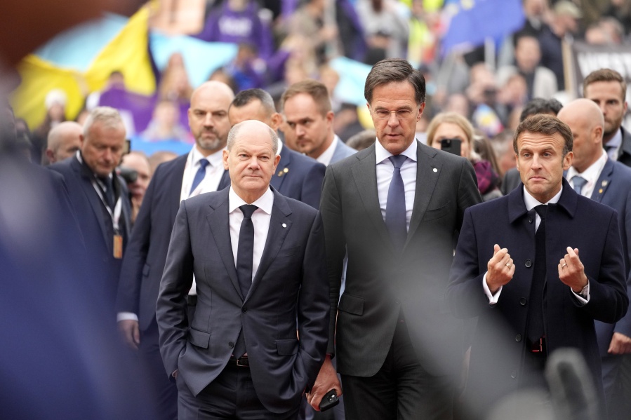 FILE - From left, Germany's Chancellor Olaf Scholz, Netherland's Prime Minister Mark Rutte and French President Emmanuel Macron arrive for an EU Summit at Prague Castle in Prague, Czech Republic, Friday, Oct 7, 2022. European Union leaders enter a crucial stretch this week to make sure runaway energy prices and short supplies do not further tank their struggling economies and foment unrest. At the same time, they need to keep all 27 members united in their opposition of Russian President Vladimir Putin.