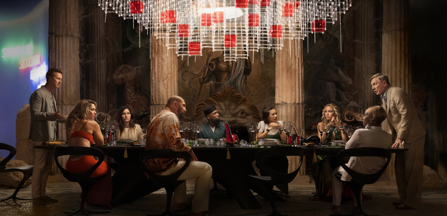 From left: Edward Norton, Madelyn Cline, Kathryn Hahn, Dave Bautista, Leslie Odom Jr., Jessica Henwick, Kate Hudson, Janelle Monae and Daniel Craig perform in a scene from "Glass Onion: A Knives Out Mystery." (Netflix)