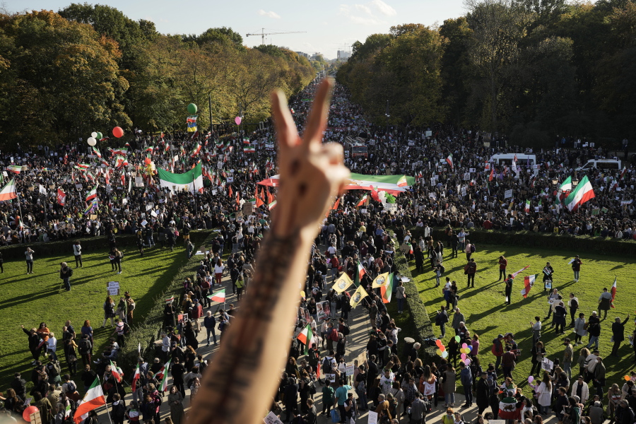 A man gestures as people attend a protest against the Iranian regime, in Berlin, Germany, Saturday, Oct. 22, 2022, following the death of Mahsa Amini in the custody of the Islamic republic's notorious "morality police". The 22-year-old died in Iran while in police custody on Sept. 16 after her arrest three days prior for allegedly violating its strictly-enforced dress code.