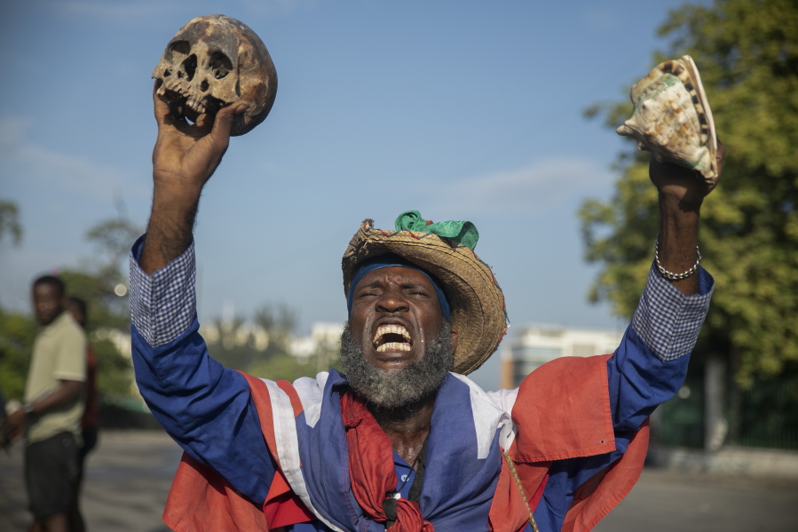 A protester holding up a skull and seashell shouts for the resignation of Haitian Prime Minister Ariel Henry in the street in the Champs de Mars area where the prime minister attended a ceremony marking the death anniversary of revolutionary leader Jean-Jacques Dessalines in Port-au-Prince, Haiti, Monday, Oct. 17, 2022.