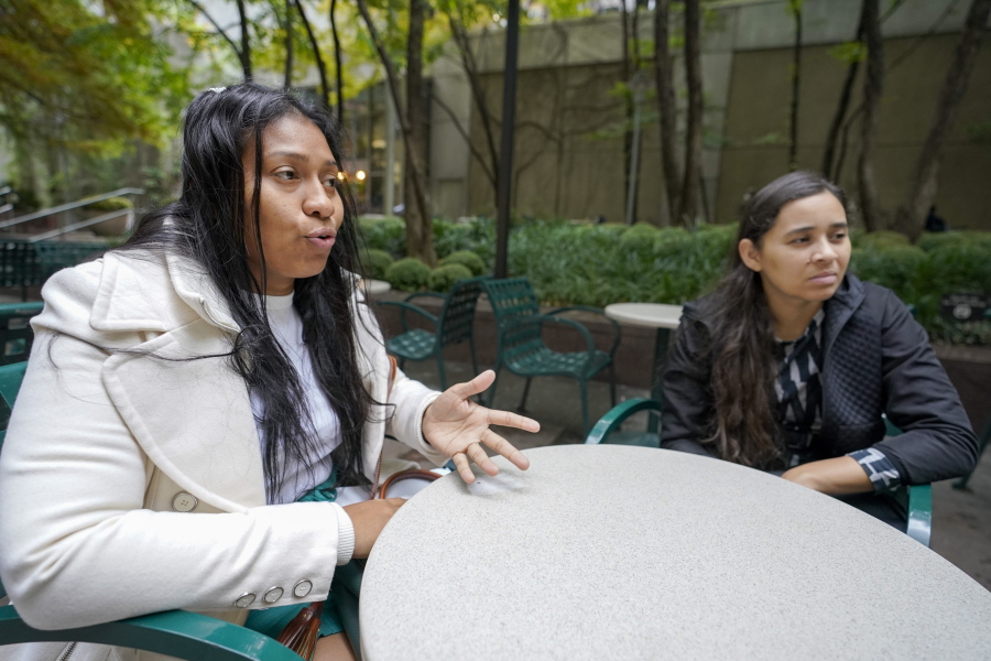 Venezuelans Yeysy Hernandez, left, and Candy Cegarra speak during an interview with The Associated Press, Thursday, Oct. 13, 2022, in New York.