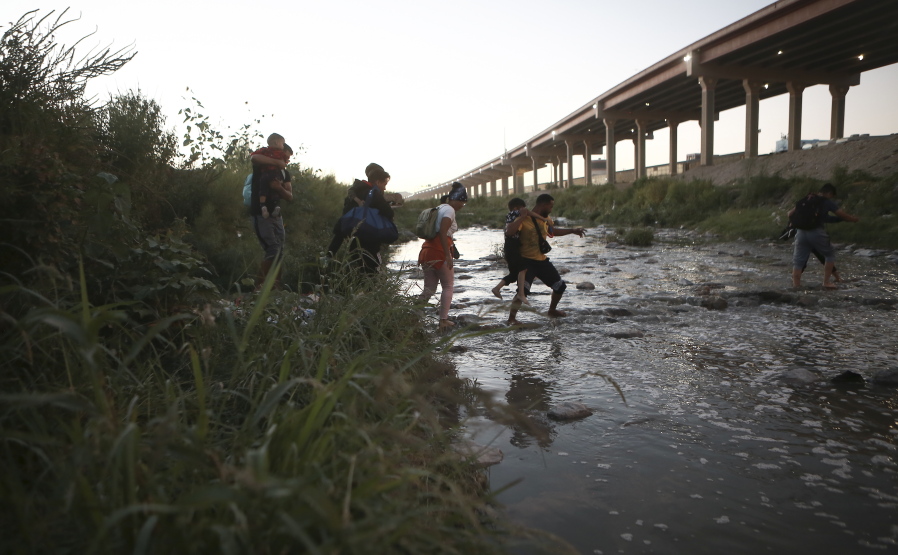FILE - Venezuelan migrants walk across the Rio Bravo towards the United States border to surrender to the border patrol, from Ciudad Juarez, Mexico, Oct. 13, 2022. A surge in migration from Venezuela, Cuba and Nicaragua in September brought the number of illegal crossings to the highest level ever recorded in a fiscal year, according to U.S. Customs and Border Protection.
