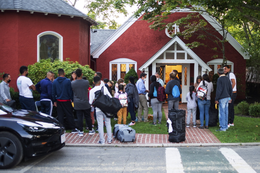 Immigrants gather with their belongings outside St. Andrews Episcopal Church, Wednesday Sept. 14, 2022, in Edgartown, Mass., on Martha's Vineyard. Florida Gov. Ron DeSantis on Wednesday flew two planes of immigrants to Martha's Vineyard, escalating a tactic by Republican governors to draw attention to what they consider to be the Biden administration's failed border policies.