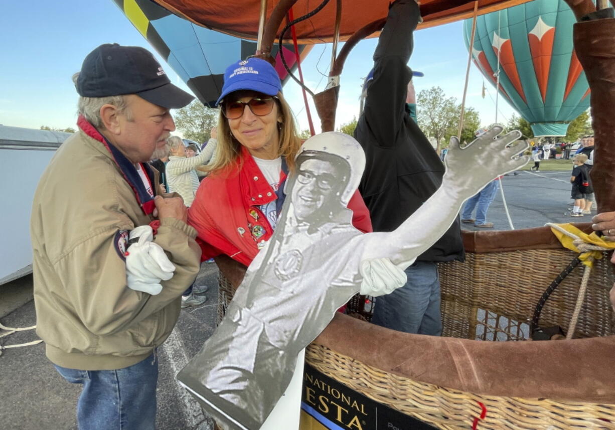 Denise Wiederkehr McDonald, center, holds a cardboard cutout of her father as part of a re-enactment of the first Albuquerque International Balloon Fiesta in 1972 during a special event at Coronado Center in Albuquerque, New Mexico, on Friday, Sept. 30, 2022. Wiederkehr's father was among the original 13 pilots to take part in the first fiesta.