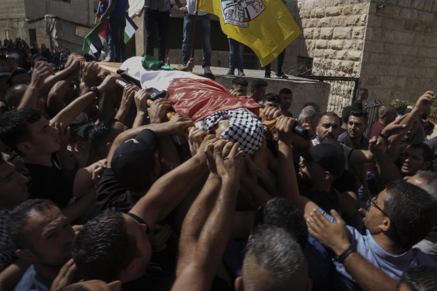 FILE - Mourners carry the body of 7-year-old Palestinian boy Rayan Suleiman during his funeral in the West Bank village of Tequa near Bethlehem Friday, Sept. 30, 2022. The Israeli military on Thursday, Oct. 6,  cleared itself of wrongdoing in the death of a 7-year-old Palestinian boy whose family says he "died of fear" after an interaction with Israeli soldiers in the occupied West Bank.