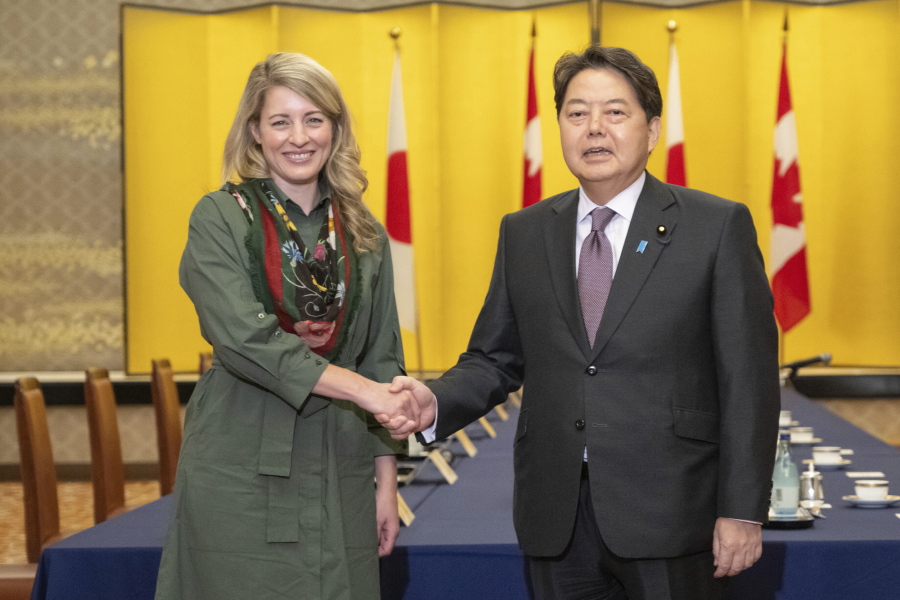 Canadian Foreign Minister Melanie Joly and Japanese Foreign Minister Yoshimasa Hayashi shake hands prior to their meeting at the Iikura Guest House in Tokyo, Tuesday, Oct. 11, 2022.