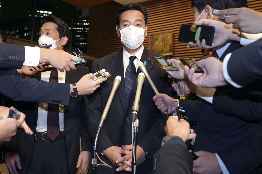 Japan's Economy Minister Daishiro Yamagiwa is surrounded by reporters at the prime minister's official residence in Tokyo, Monday, Oct. 24, 2022.