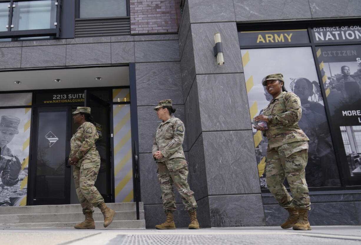 FILE - The U.S. Army National Guard members stand outside the Army National Guard office during training on April 21, 2022, in Washington. The Army fell about 15,000 soldiers -- or 25% -- short of its recruitment goal this year, officials confirmed Friday, Sept. 30, despite a frantic effort to make up the widely expected gap in a year when all the military services struggled in a tight jobs market to find young people willing and fit to enlist.
