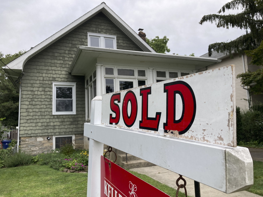 FILE - A "sold" is posted outside a single family home in a residential neighborhood, in Glenside, Pa., Wednesday, Aug. 4, 2021.  Mortgage buyer Freddie Mac reported Thursday, Oct.