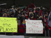 FILE - Portland Thorns fans hold signs during the first half of the team's NWSL soccer match against the Houston Dash in Portland, Ore., Wednesday, Oct. 6, 2021. An independent investigation into the scandals that erupted in the National Women's Soccer League last season found emotional abuse and sexual misconduct were systemic in the sport, impacting multiple teams, coaches and players, according to a report released Monday, Oct. 3, 2022.