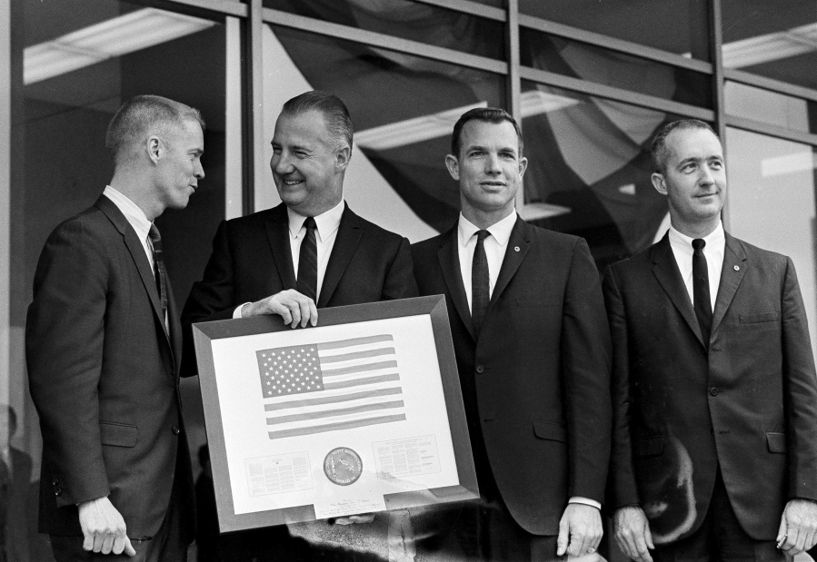 FILE - Vice President Spiro Agnew holds a framed American flag, presented to him by the crew of Apollo 9, as he poses with the astronauts March 26, 1969, in Washington. From left: Russell Schweikart, Agnew, and Air Force Cols. David Scott and James McDivitt. McDivitt, who commanded the Apollo 9 mission testing the first complete set of equipment to go to the moon, died Thursday, Oct. 13, 2022. He was 93.