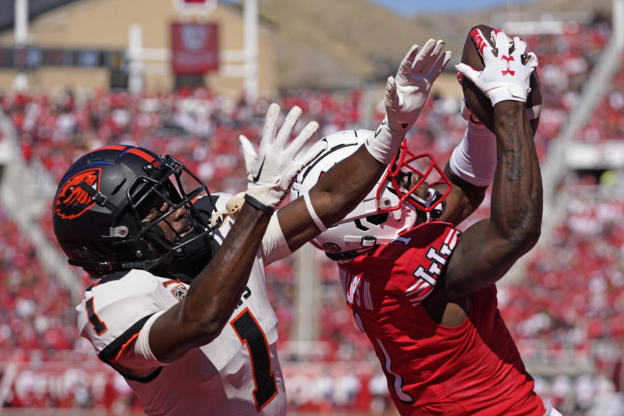 Utah cornerback Clark Phillips III, right, intercepts the ball from Oregon State wide receiver Tyjon Lindsey (1) during the second half of an NCAA college football game, Saturday, Oct. 1, 2022, in Salt Lake City.