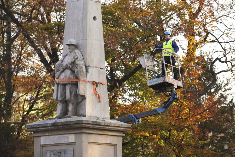A worker stands on a crane during dismantling of a Red Army monument in Glubczyce, Poland, Thursday, Oct. 27, 2022. Poland on Thursday dismantled four communist-era monuments to Red Army soldiers in a renewed drive to remove symbols of Moscow's post-World War II domination and to stress its condemnation of Moscow's current war on neighbouring Ukraine. Workers used drills and heavy equipment to destroy the 1945 monuments at four different locations across Poland. Most of them were in the form of concrete obelisks dedicated to Red Army soldiers who fell while fighting to defeat Nazi German troops.