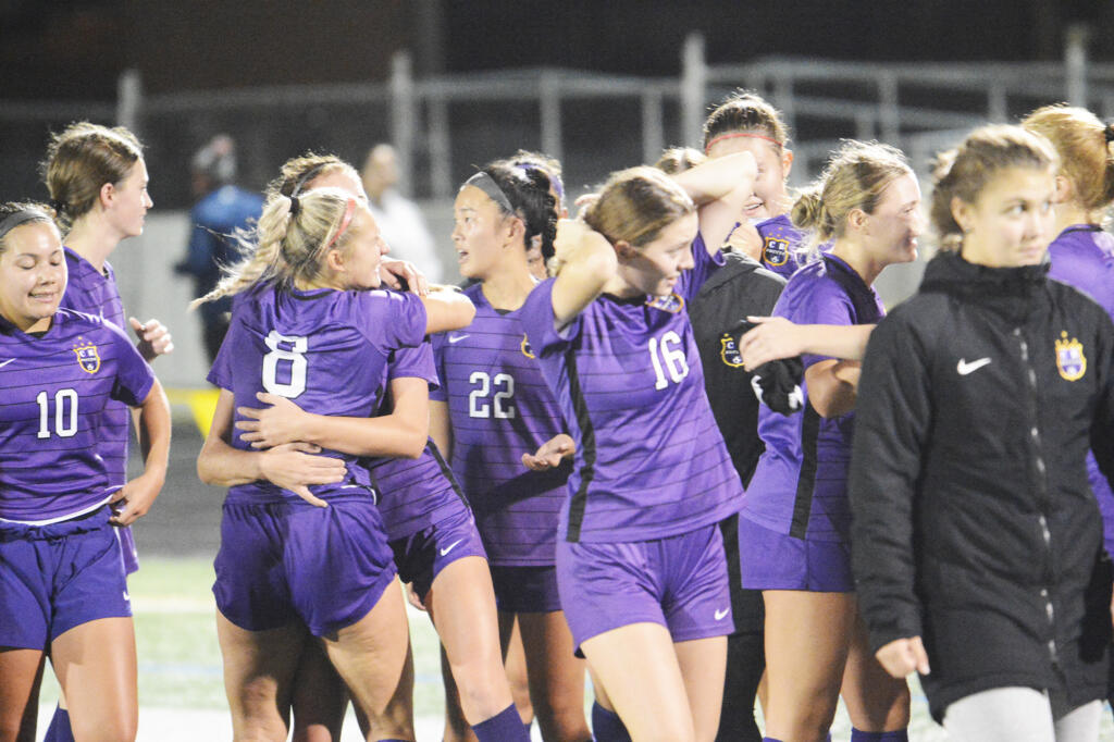 Columbia River girls soccer players celebrate their 2-1 win over Ridgefield on Tuesday, Oct. 4, 2022.