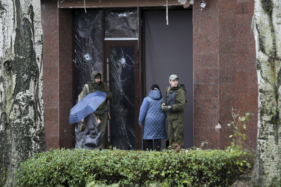 Servicemen guard the entrance of a government building in Donetsk, the capital of Donetsk People's Republic, eastern Ukraine, Thursday, Oct. 20, 2022. Russian President Vladimir Putin made on Wednesday a declaration of martial law in the four illegally annexed regions.