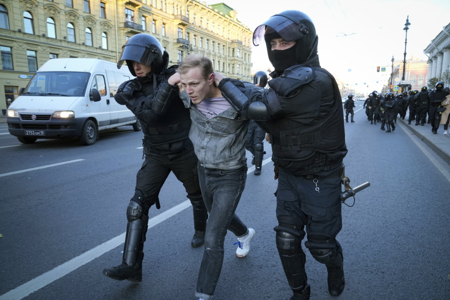 Russian policemen detain a demonstrator protesting against mobilization in St. Petersburg, Russia, Saturday, Sept. 24, 2022. Eight months after Russian President Vladimir Putin launched an invasion against Ukraine expecting a lightening victory, the war continues, affecting not just Ukraine but also exacerbating death and tension in Russia among its own citizens.