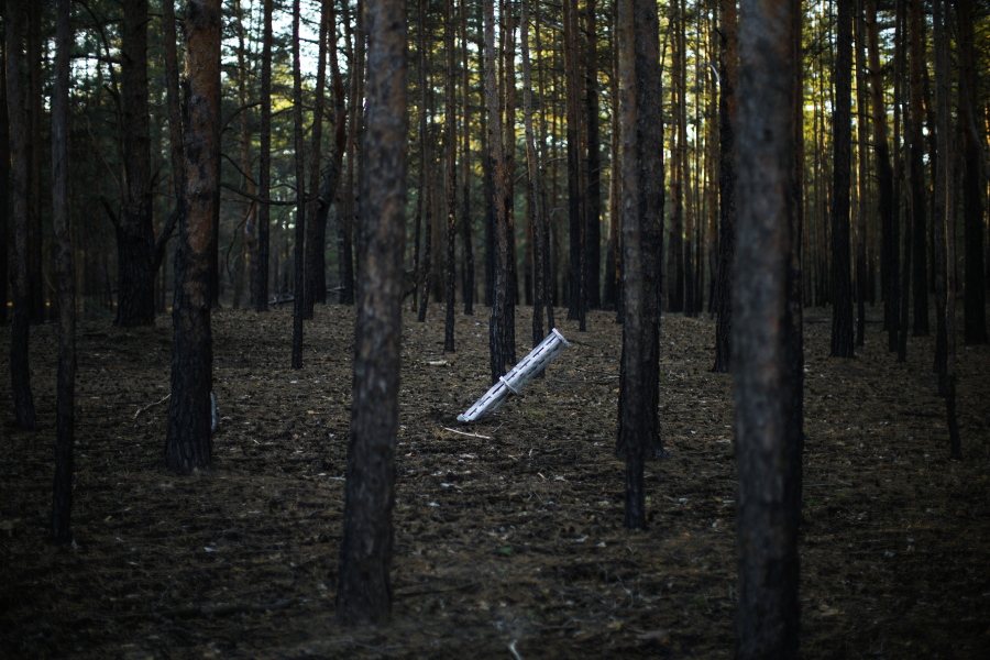 A Russian rocket sticks out of the ground in a forest near Oleksandrivka village, Ukraine, Thursday, Oct. 6, 2022.