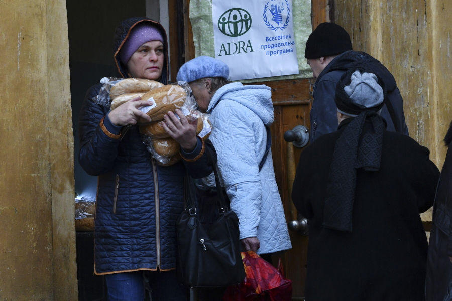 People receive bread at humanitarian aid center in Kramatorsk, Ukraine, Wednesday, Oct. 26, 2022.