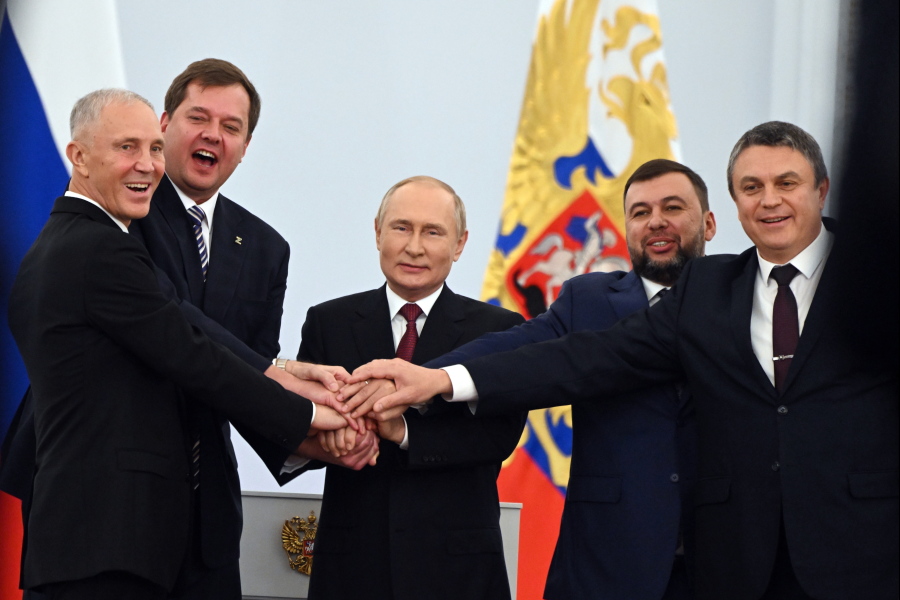 FILE - From left, Moscow-appointed head of Kherson Region Vladimir Saldo, Moscow-appointed head of Zaporizhzhia region Yevgeny Balitsky, Russian President Vladimir Putin, center, Denis Pushilin, leader of self-proclaimed of the Donetsk People's Republic and Leonid Pasechnik, leader of self-proclaimed Luhansk People's Republic pose for a photo during a ceremony to sign the treaties for four regions of Ukraine to join Russia, at the Kremlin in Moscow, on Sept. 30, 2022.