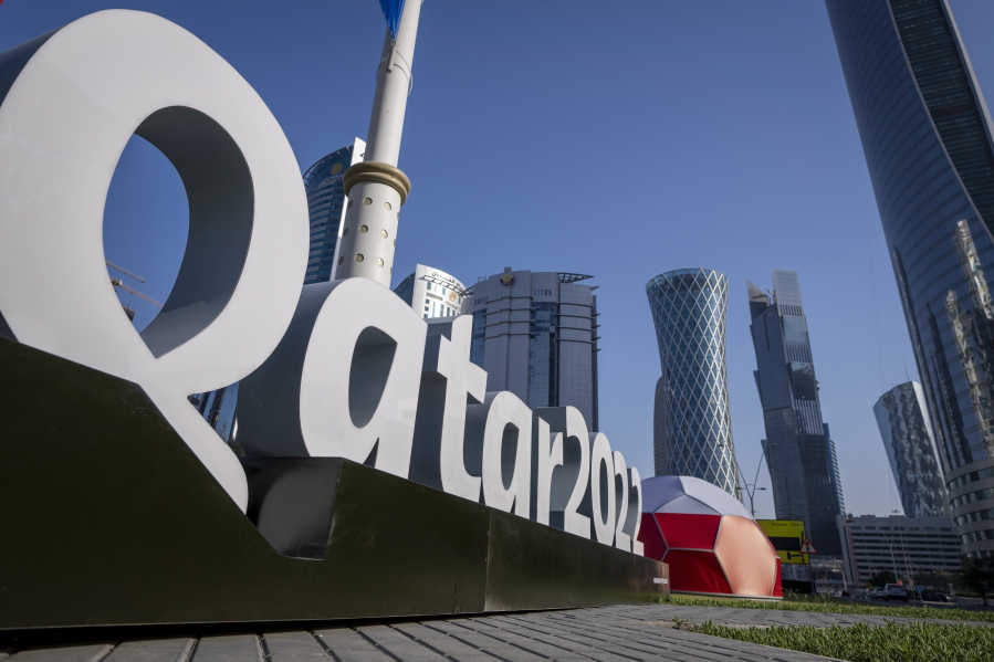 FILE - Branding is displayed near the Doha Exhibition and Convention Center in Doha, Qatar, Thursday, March 31, 2022. Qatar's ruling emir has lashed out at criticism of the country over its hosting of the 2022 FIFA World Cup, complaining of an "unprecedented campaign" targeting the first Arab nation to hold the tournament.