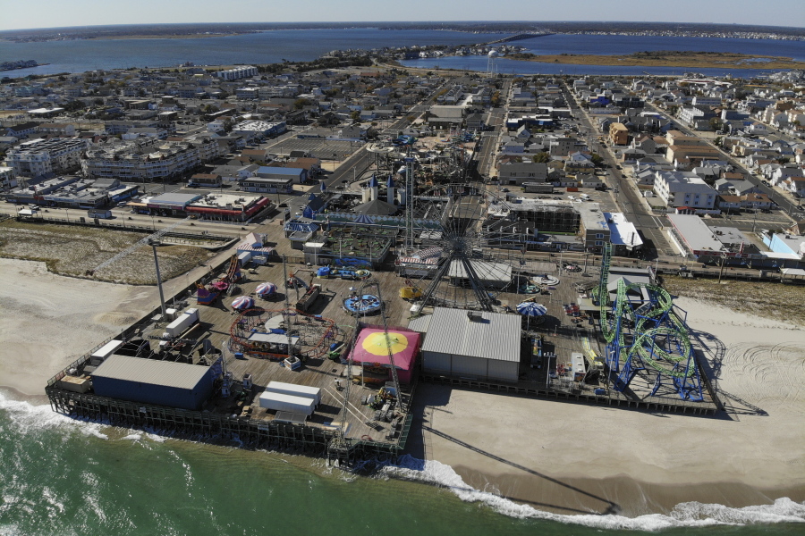 An amusement park sits next to the ocean in Seaside Heights, N.J., Thursday, Oct. 20, 2022. The Jet Star roller coaster, whose collapse into the ocean at Seaside Heights, N.J. during Sandy provided an iconic image of the storm's destruction, has been replaced with a new ride, built on the beach instead of over the water like its predecessor.
