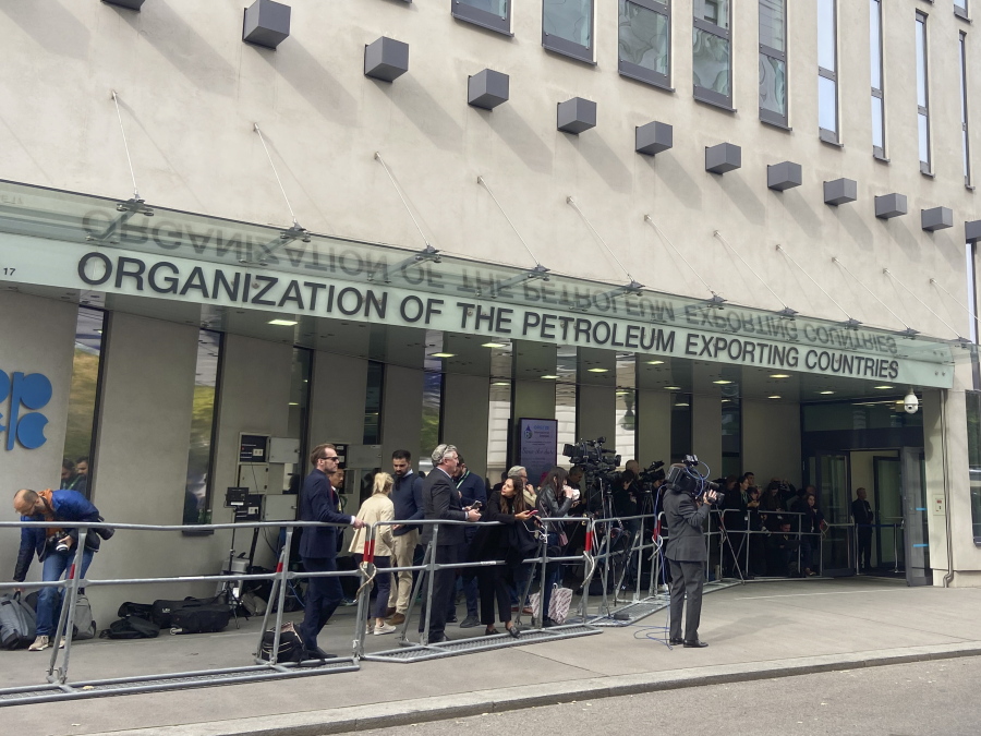 FILE - People and media gather at the entrance of the building of the Organization of the Petroleum Exporting Countries, OPEC, in Vienna, Austria on Oct. 5, 2022. Saudi Arabia said Thursday, Oct. 13, 2022 that the U.S. had urged the kingdom to postpone a decision by OPEC and its allies, including Russia, to cut oil production by a month which would have been just before the upcoming American midterm elections.