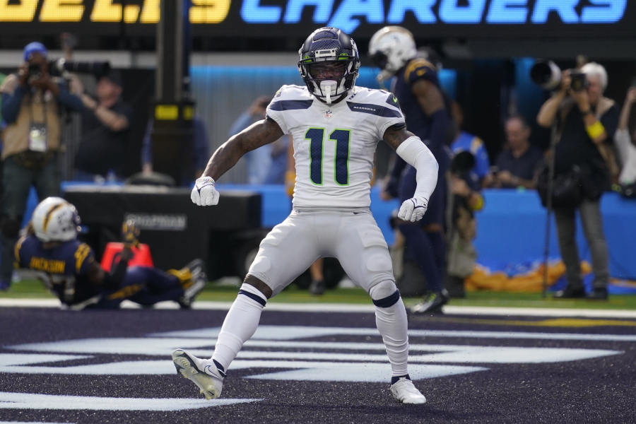 Seattle Seahawks wide receiver Marquise Goodwin (11) celebrates after scoring a touchdown during the first half of an NFL football game against the Los Angeles Chargers Sunday, Oct. 23, 2022, in Inglewood, Calif. (AP Photo/Mark J.