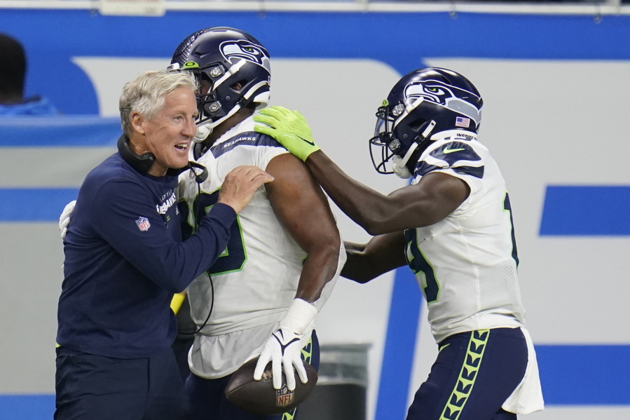 Seattle Seahawks head coach Pete Carroll hugs running back Rashaad Penny after Penny's touchdown during the second half of an NFL football game against the Detroit Lions, Sunday, Oct. 2, 2022, in Detroit.