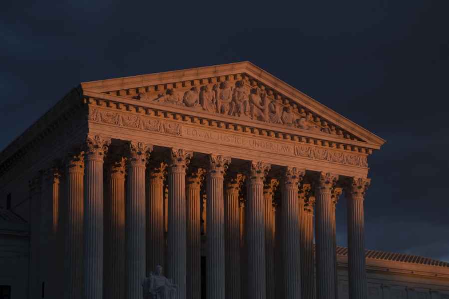 The Supreme Court is seen at sunset in Washington, on Jan. 24, 2019. The Supreme Court will hear arguments on Oct. 11, 2022, over a California animal cruelty law that could raise the cost of bacon and other pork products nationwide. (AP Photo/J.
