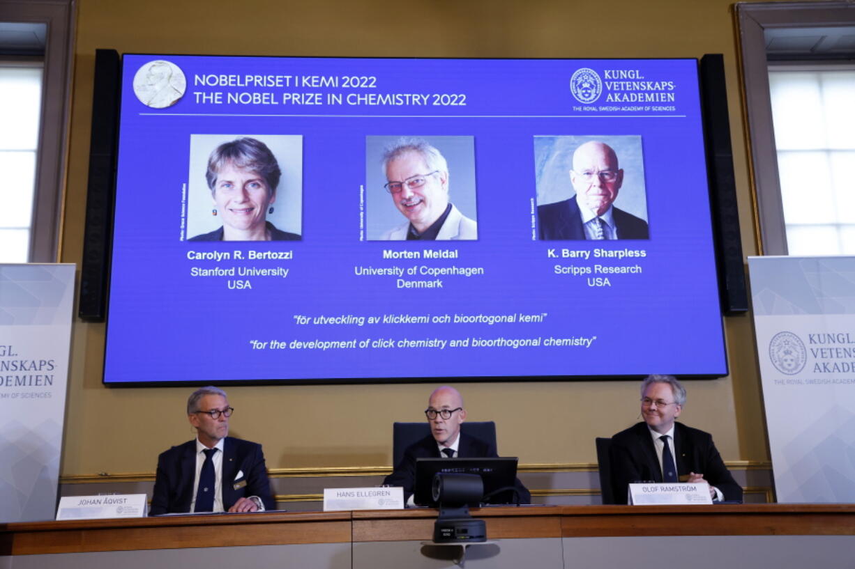 Secretary General of the Royal Swedish Academy of Sciences Hans Ellegren, centre, Jonas Aqvist, Chairman of the Nobel Committee for Chemistry, left, and Olof Ramstrom, member of the Nobel Committee for Chemistry announce the winners of the 2022 Nobel Prize in Chemistry during a press conference at the Royal Swedish Academy of Sciences in Stockholm, Sweden, Wednesday, Oct. 5, 2022. The winners of the 2022 Nobel Prize in chemistry are Caroline R. Bertozzi of the United States, Morten Meldal of Denmark and K. Barry Sharpless of the United States.