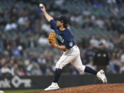 Seattle Mariners catcher Luis Torrens pitches against the Detroit Tigers during the 10th inning of the first game of a baseball doubleheader, Tuesday, Oct. 4, 2022, in Seattle.