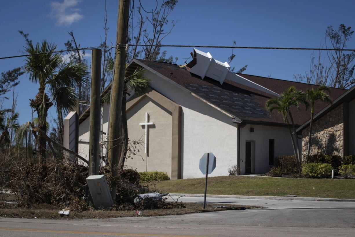 The steeple lays on its side atop Southwest Baptist Church in Fort Myers, Fla., on Sunday, Oct. 2, 2022. The church sustained heavy wind and flooding damage during Hurricane Ian as parishioners took refuge in the sanctuary.