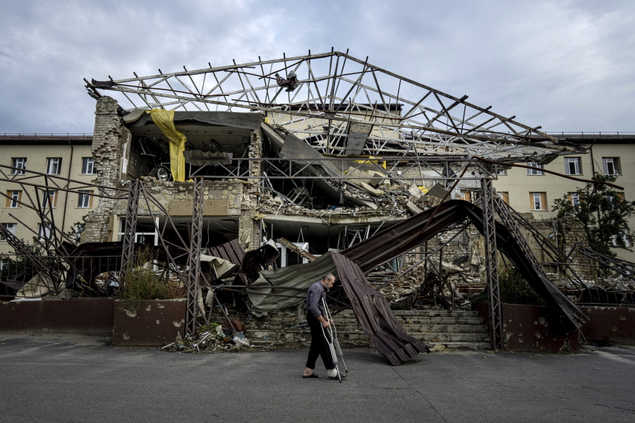 A patient walks past the surgery department which was destroyed after a Russian attack at the hospital in Izium, Ukraine, Saturday, Sept. 17, 2022. Medical staff at the Izium hospital in eastern Ukraine are fighting the memories of six deadly months under Russian occupation. They also are looking darkly ahead at the coming months without electricity.
