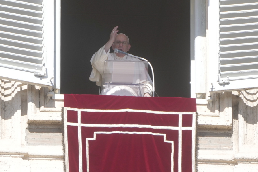 Pope Francis blesses the faithful from his studio's window overlooking St. Peter's Square on the occasion of the Angelus noon prayer at the Vatican, Sunday, Oct.