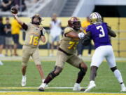 Arizona State quarterback Trenton Bourguet (16) throws a pass as offensive lineman Isaia Glass (73) blocks Washington defensive lineman Jeremiah Martin (3) during the second half of an NCAA college football game in Tempe, Ariz., Saturday, Oct. 8, 2022. (AP Photo/Ross D.