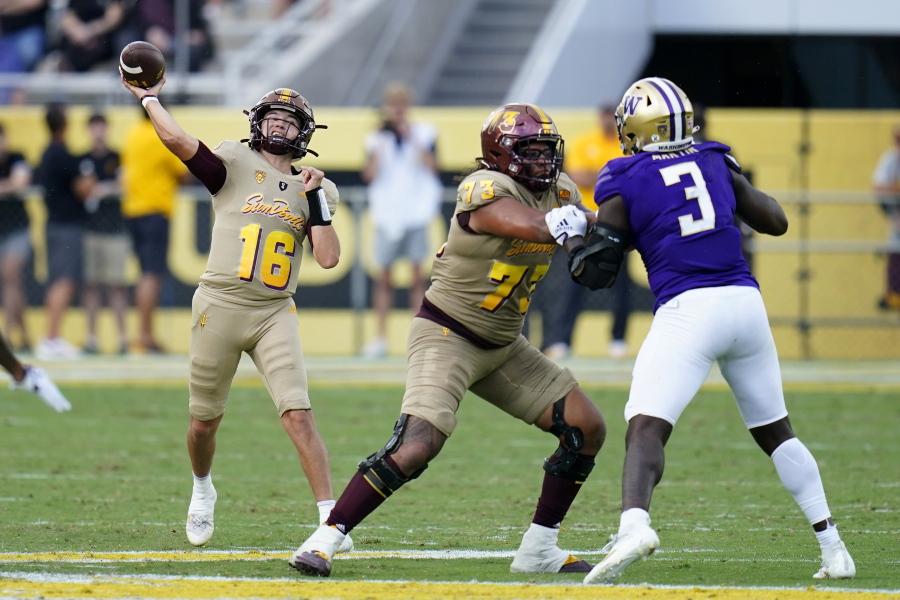 Arizona State quarterback Trenton Bourguet (16) throws a pass as offensive lineman Isaia Glass (73) blocks Washington defensive lineman Jeremiah Martin (3) during the second half of an NCAA college football game in Tempe, Ariz., Saturday, Oct. 8, 2022. (AP Photo/Ross D.
