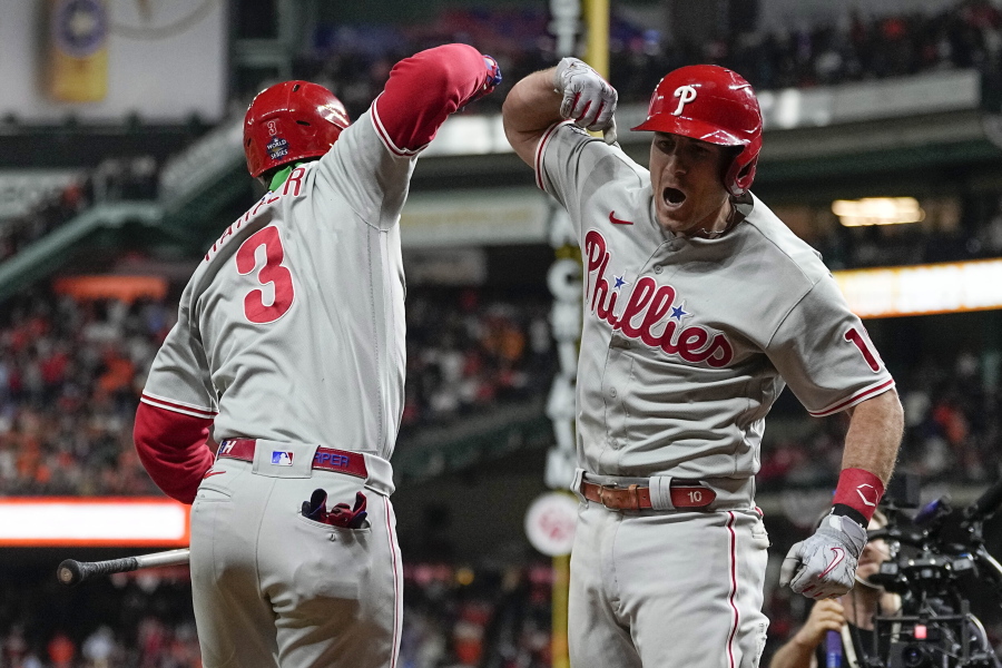 Philadelphia Phillies' J.T. Realmuto, right, celebrates his solo homer with Philadelphia Phillies Bryce Harper during the 10th inning in Game 1 the World Series on Friday.