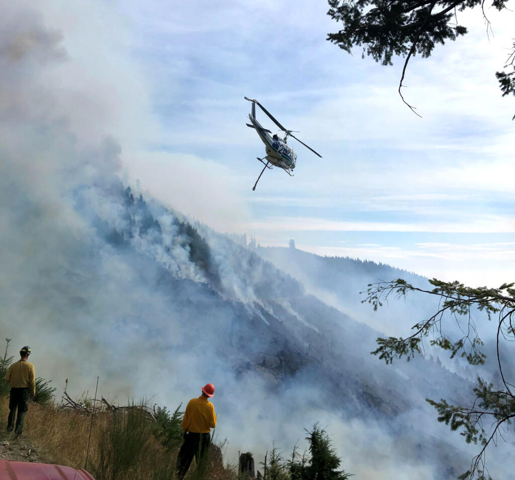 A helicopter drops water on the Nakia Creek Fire in east Clark County on Tuesday.