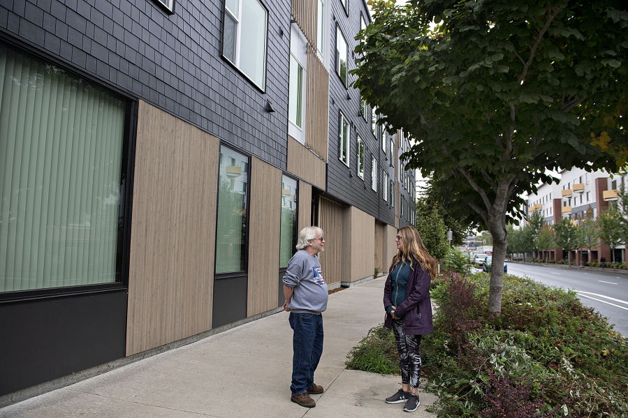 James Donahue, left, and Stella Kirkman chat outside Miles Terrace, an affordable housing development for low-income seniors where they live. Kirkman said if she hadn't gotten a unit at Miles Terrace, she would likely be living in her car.