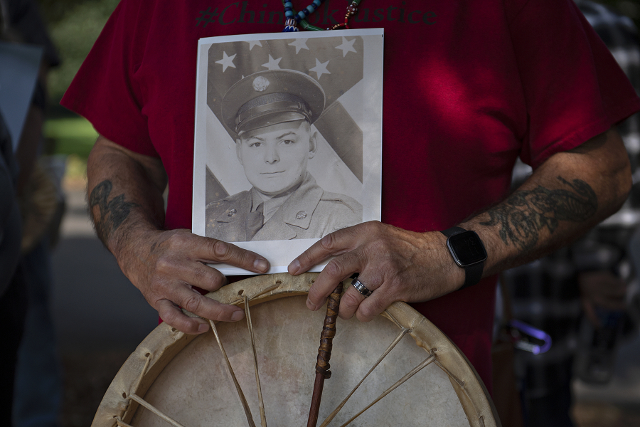 Sam Robinson, vice chairman of the Chinook Indian Nation, displays a photo of his father, Korean War veteran Scott Robinson, at an Oct. 7 rally for federal tribal recognition for the Chinook at Fort Vancouver National Historic Site.