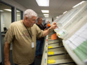 Clark County Elections Office ballot processing is underway as Election Day approaches. Gregg Peck, an inspection board worker, sorts ballots into their districts.