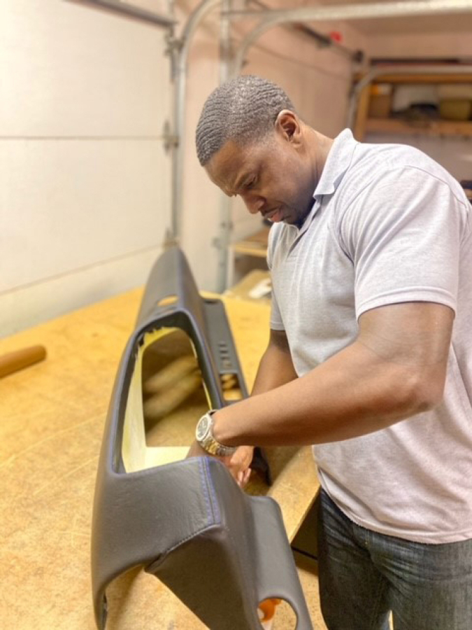 Jheraun "J.D." Dunlap upholsters a door trim panel for one of his clients. Tailor Made Stitching also does a lot of car seat restoration work.